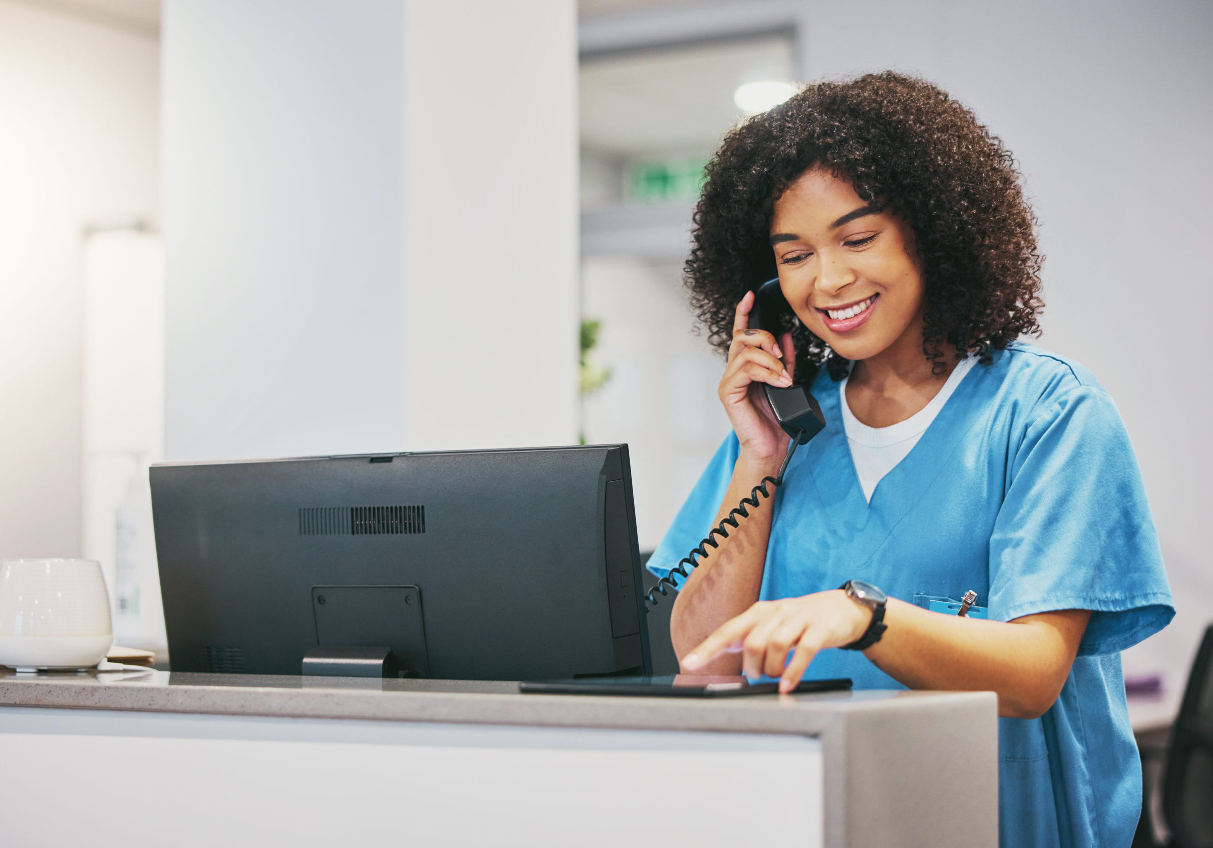 Nurse, phone call and tablet of black woman at hospital with a smile. Clinic doctor, healthcare wor.