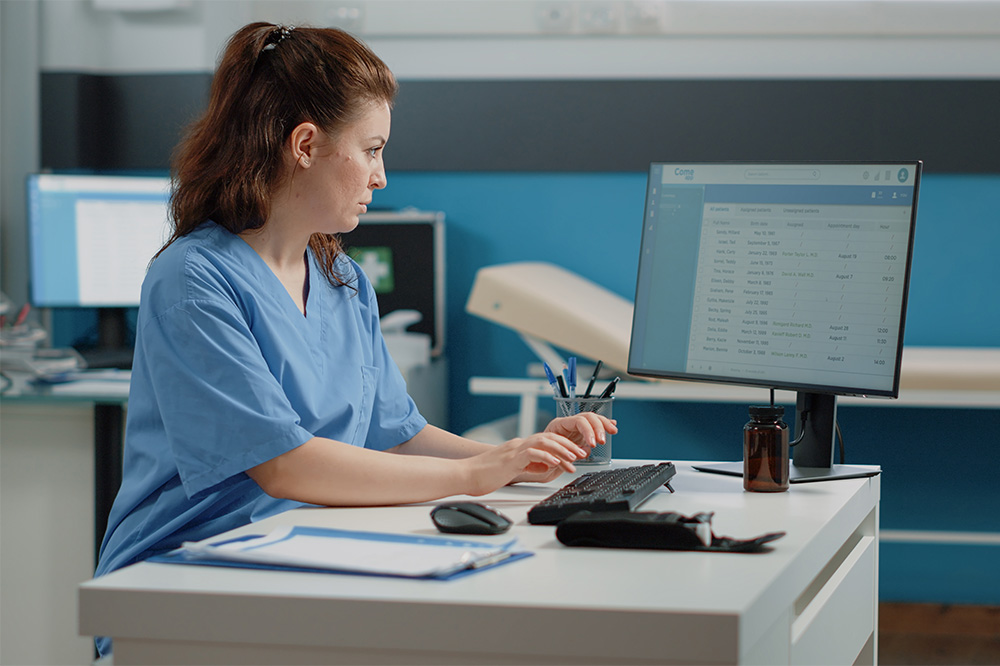 nurse-typing-on-computer-keyboard-for-consultation-2025-02-22-18-46-00-utc