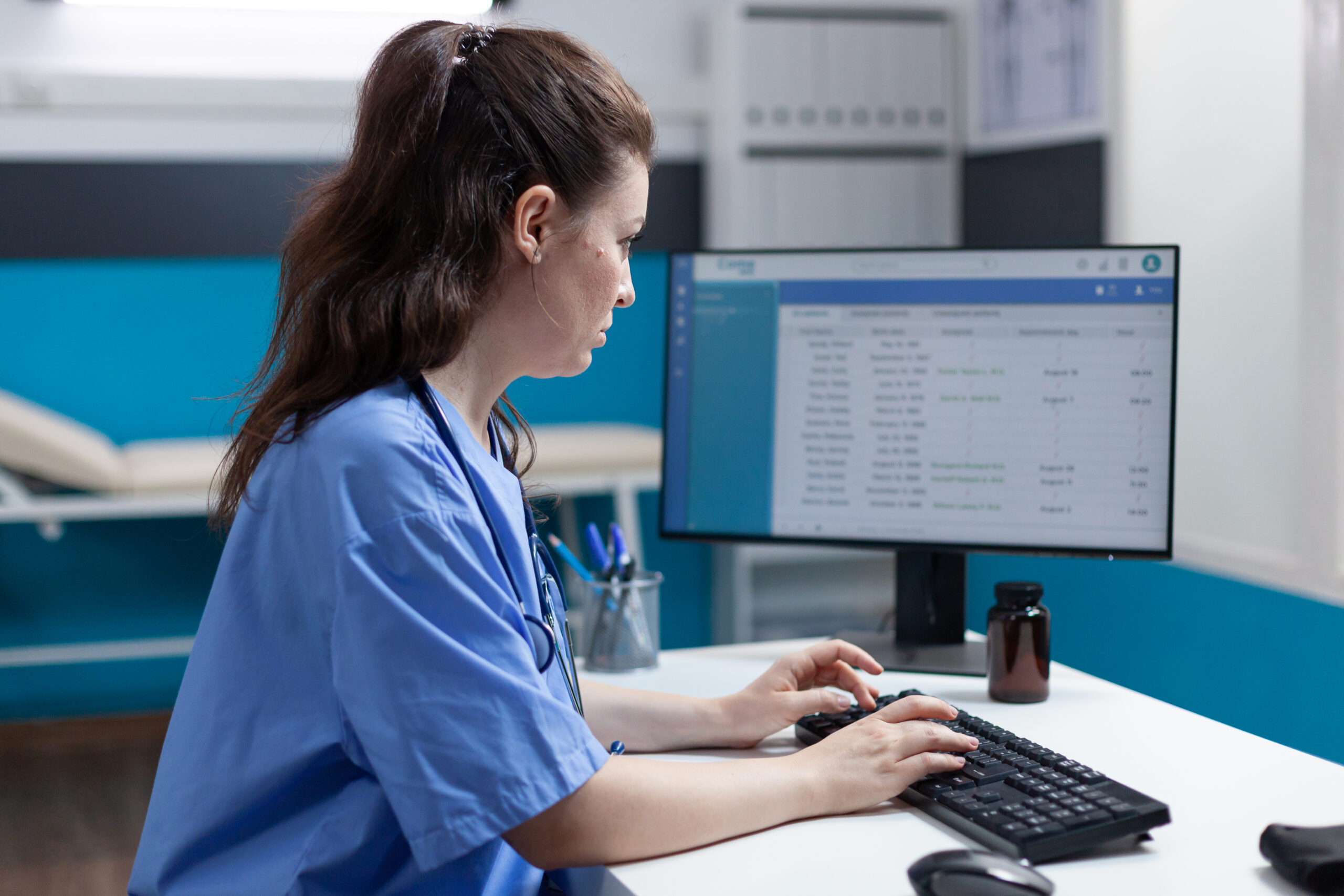 Practitioner specialist nurse analyzing medical examination using computer Practitioner specialist nurse analyzing medical examination using computer in hospital office during clinical appointment. Pharmacist asisstance checking pharmaceutical medication. Halth check